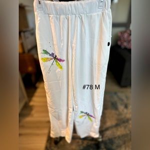 Cream capri length size M, new butterfly design on leg.